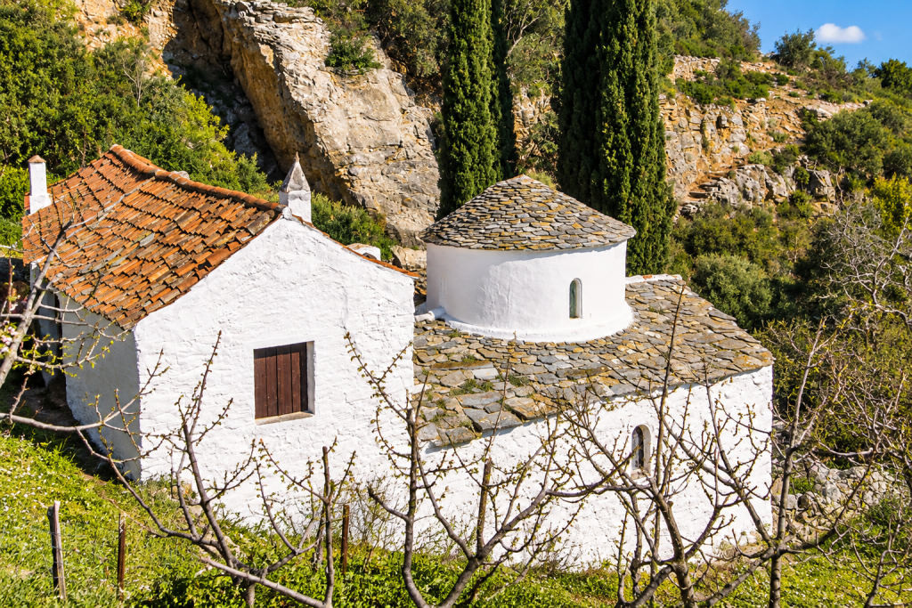 Monastery of Agioi Taxiarches on Skopelos surrounded by wooded hills.