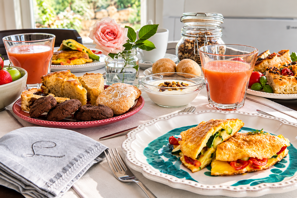 Traditional Puglian breakfast at Leonardo Trulli Resort with fresh local produce and garden vegetables.