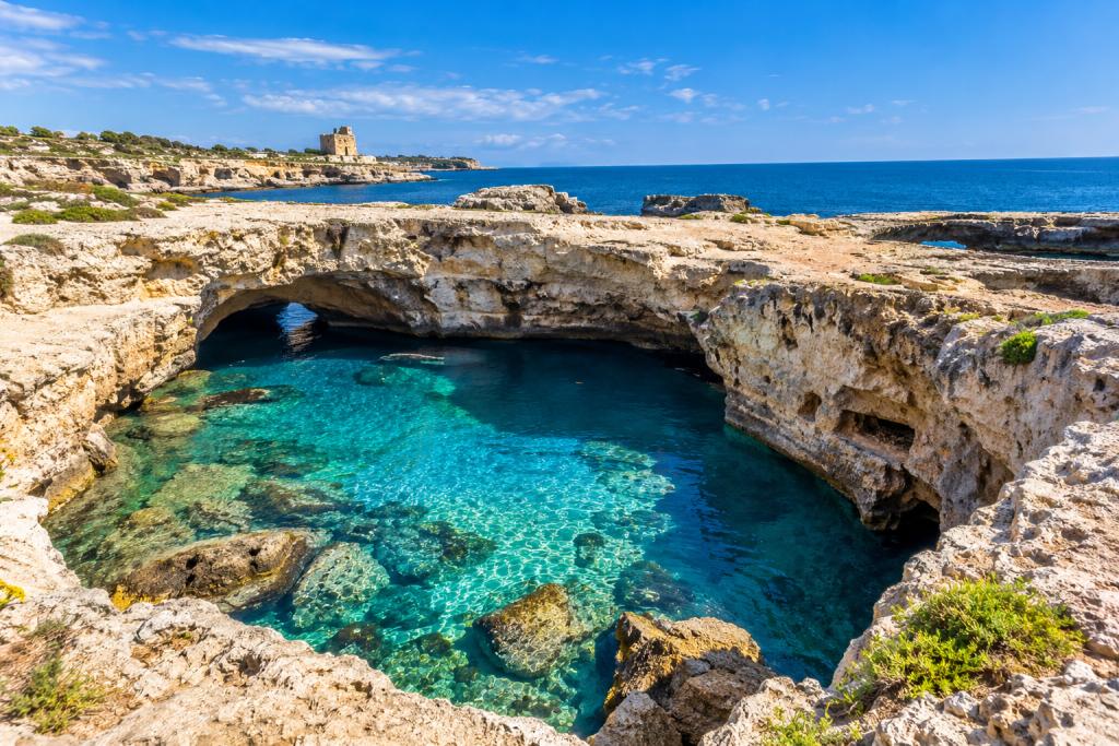 Grotta della Poesia at Roca Vecchia, a limestone coastal pool surrounded by rocky cliffs and Adriatic sea.